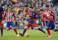 Atletico players closing down Messi in a La Liga game